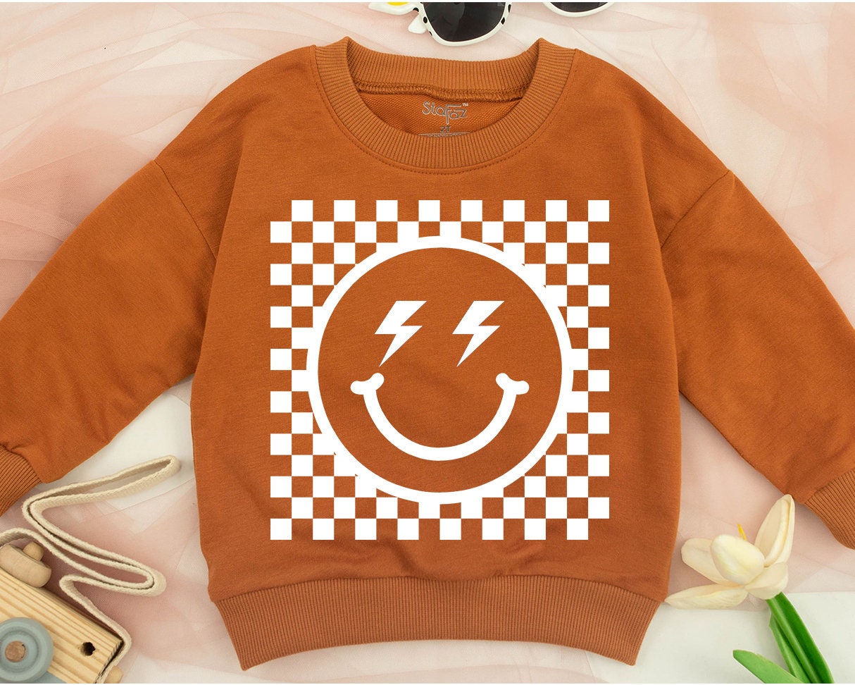 Bold Retro Checkered Smiley Face Kids Sweatshirt Vintage Happy Eye Design Playful Black and White Pattern Apparel Comfortable Toddler Youth Top