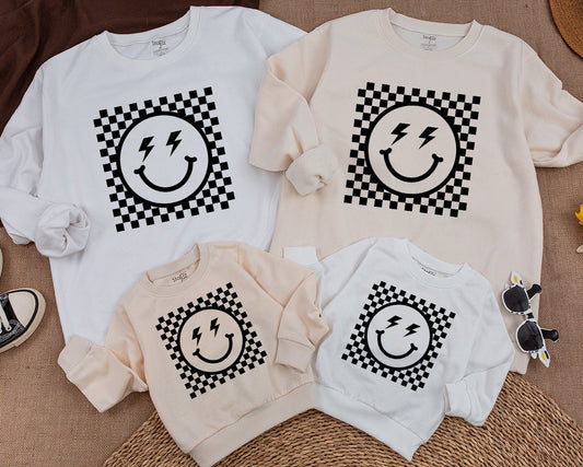 Bold Retro Checkered Smiley Face Kids Sweatshirt Vintage Happy Eye Design Playful Black and White Pattern Apparel Comfortable Toddler Youth Top