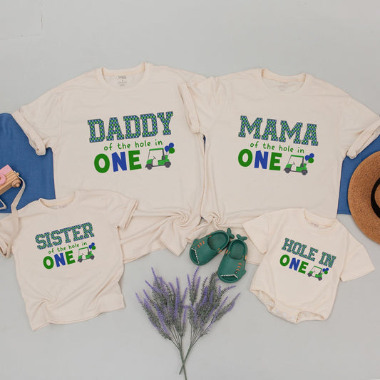Hole in One First Birthday Matching Family Golf Theme Party Shirt Outfit with Daddy Mama Brother Plaid Green Blue Design and playful Golf Cart Blue Balloons perfect for an unforgettable celebration.