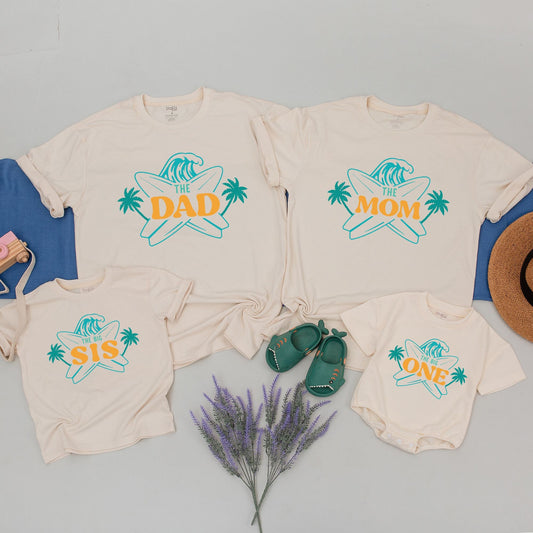 Matching Family Surf Birthday Shirts for The Big One First Birthday featuring a cool teal wave and golden palm trees perfect beach party tees