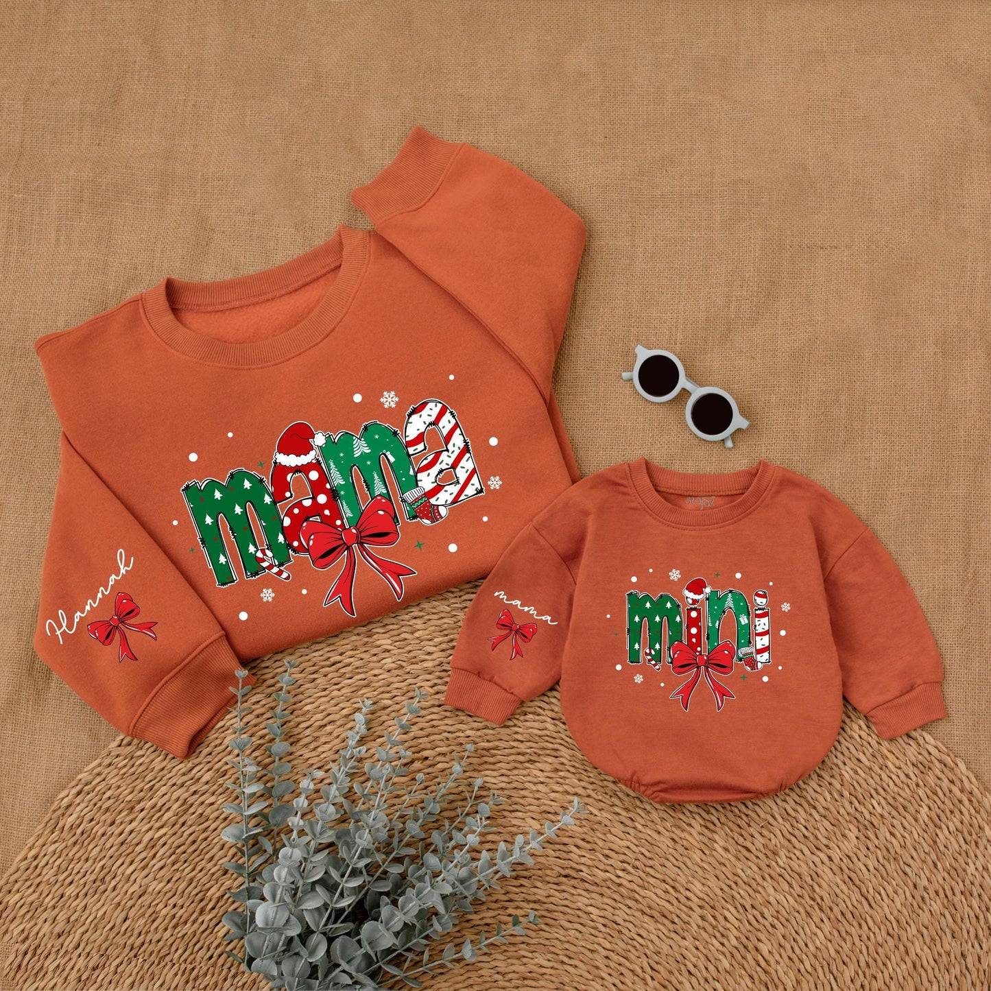 Personalized Christmas Mama Mini Matching Sweatshirt and Baby Romper featuring festive joyful candy cane Santa hat Christmas tree designs and red bows