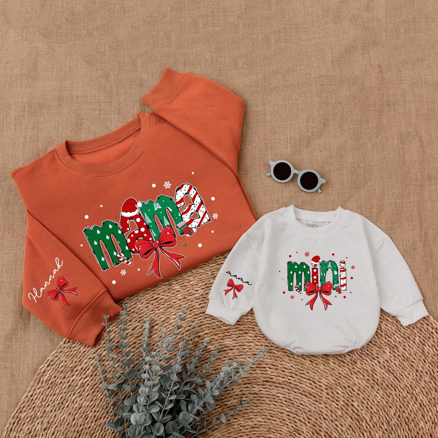 Personalized Christmas Mama Mini Matching Sweatshirt and Baby Romper featuring festive joyful candy cane Santa hat Christmas tree designs and red bows