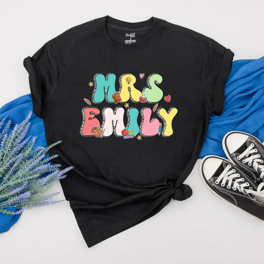 Personalized Teacher Shirt Mrs. Emily Rainbow Name Back to School Outfit, Custom Colorful Letters, Cute Heart Apple Beaker Book Pencil Graphic Gift for Women (138)