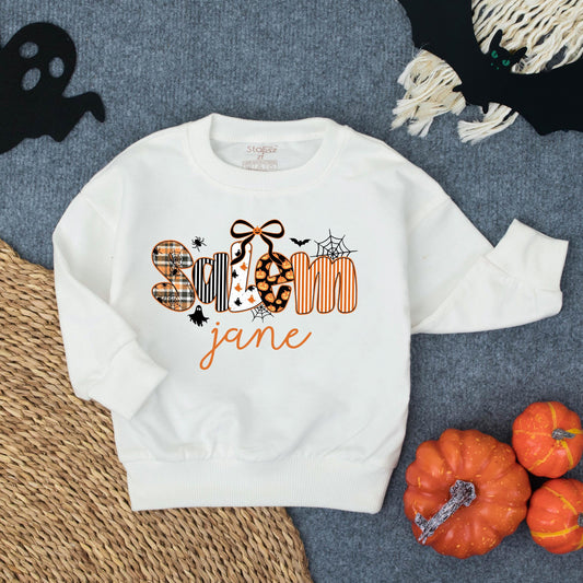 Personalized Spooky Jane Halloween Toddler Girl Sweatshirt with Stylized Letters Ghost Patterns Pumpkins Bats and Spiderwebs Fun Fall Costume