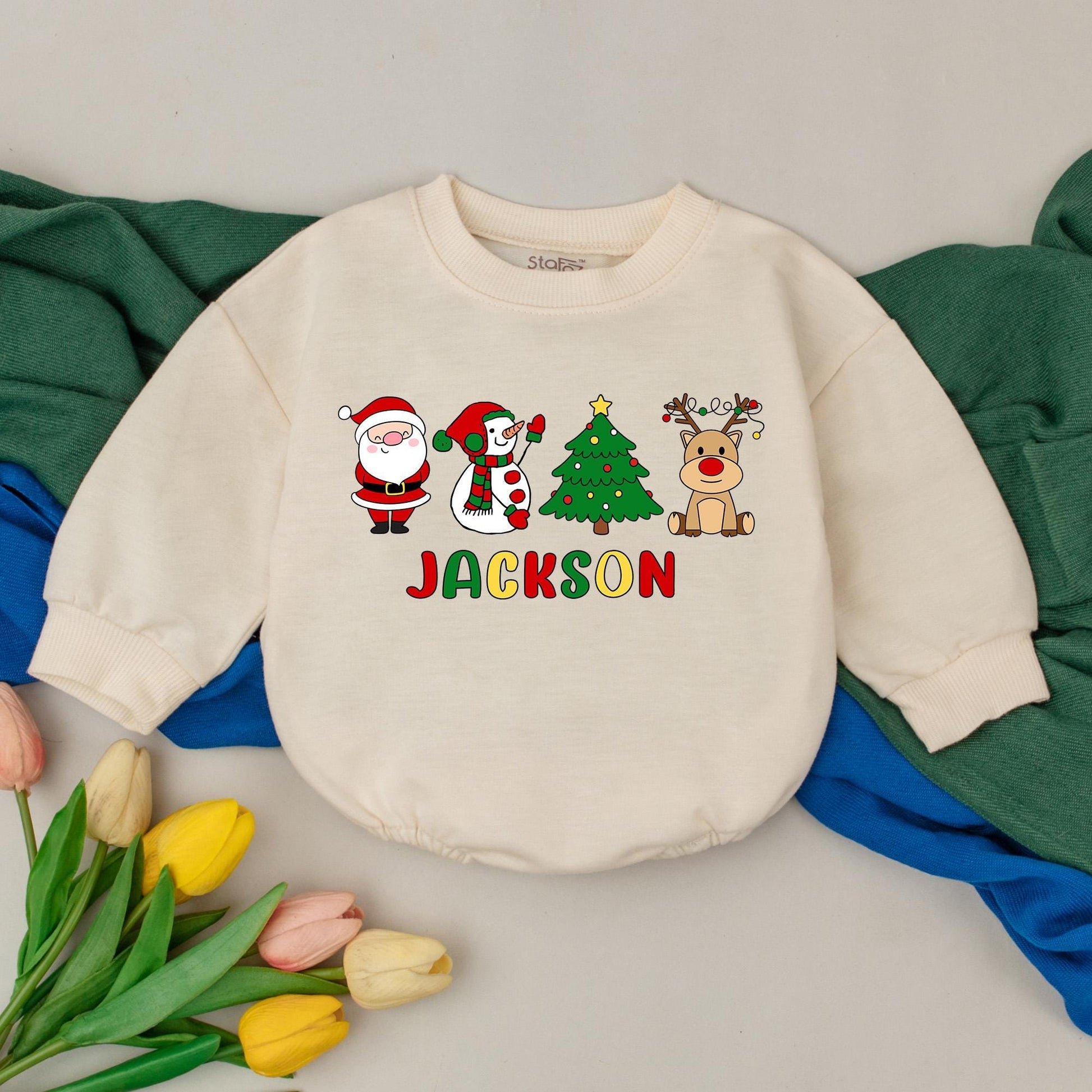 Jackson's First Christmas Bubble Romper Baby Boy Girl with Santa Snowman Tree Reindeer Design Red Green Yellow Colors Joyful Childlike Style