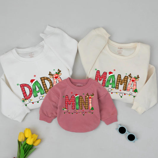 Festive Christmas Mama Mini Matching Family Sweatshirt with Playful Patterned Letters Santa Hats Reindeer Antlers Presents Trees Holiday Celebration