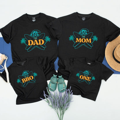 Matching Family Surf Birthday Shirts for The Big One First Birthday featuring a cool teal wave and golden palm trees perfect beach party tees