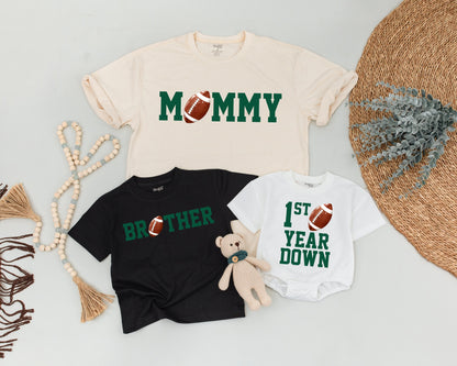 First Birthday Football Tee Daddy Mommy Brother Matching Family Outfit Green Block Letters Realistic Football Accents Playful Sporty Style