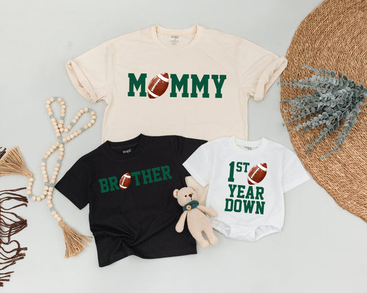 First Birthday Football Tee Daddy Mommy Brother Matching Family Outfit Green Block Letters Realistic Football Accents Playful Sporty Style