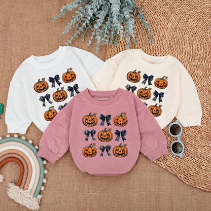 Adorable Retro Halloween Baby Romper featuring smiling jack-o'-lanterns and bows with autumn leaves a sweet first fall celebration outfit