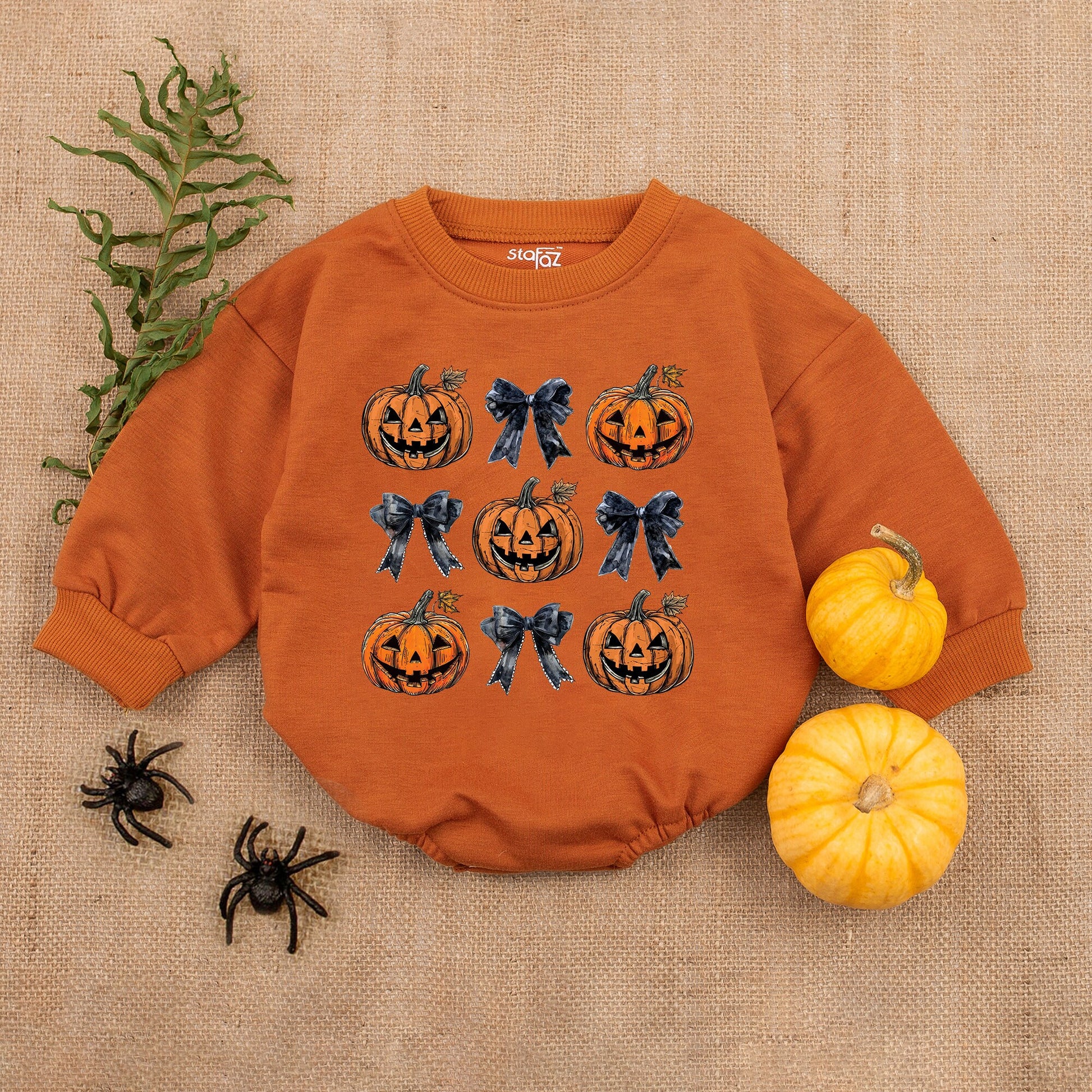 Adorable Retro Halloween Baby Romper featuring smiling jack-o'-lanterns and bows with autumn leaves a sweet first fall celebration outfit