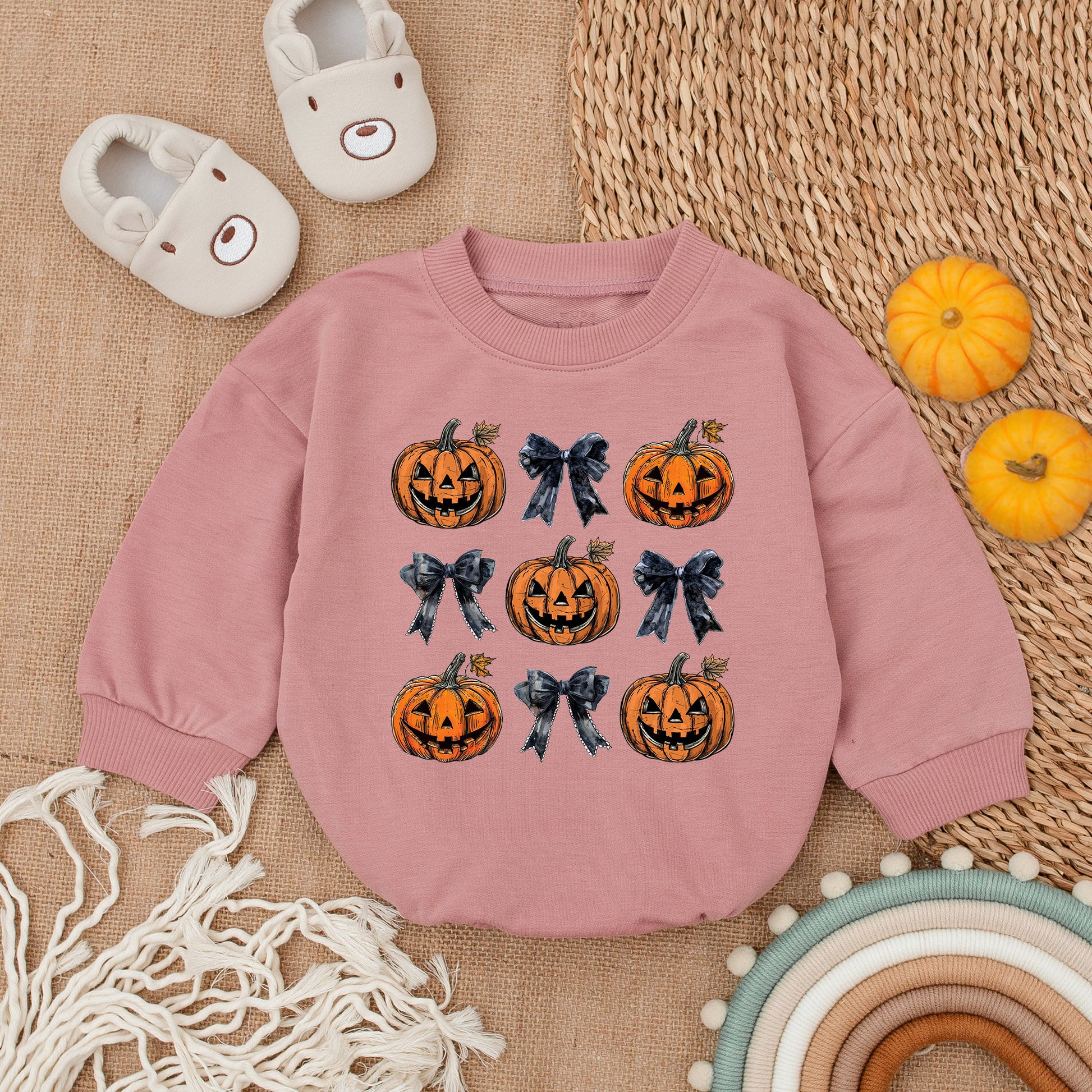 Adorable Retro Halloween Baby Romper featuring smiling jack-o'-lanterns and bows with autumn leaves a sweet first fall celebration outfit