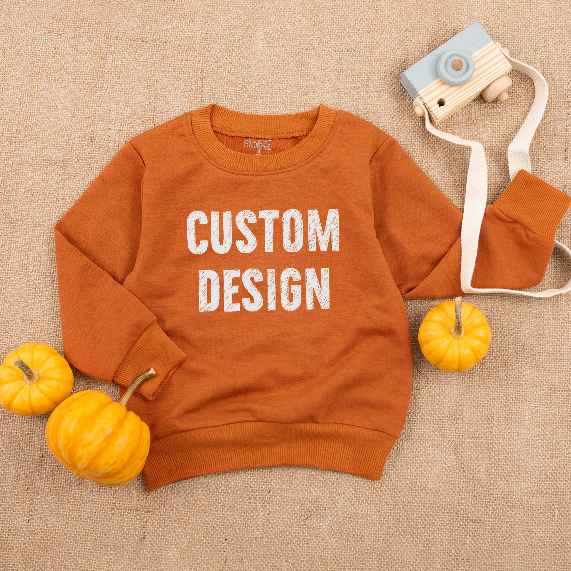 Custom Kids Sweatshirt featuring bold black 'CUSTOM DESIGN' text, a modern comfortable toddler boy girl top perfect for Christmas holiday or baby shower gift