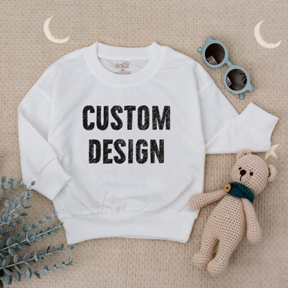 Custom Kids Sweatshirt featuring bold black 'CUSTOM DESIGN' text, a modern comfortable toddler boy girl top perfect for Christmas holiday or baby shower gift