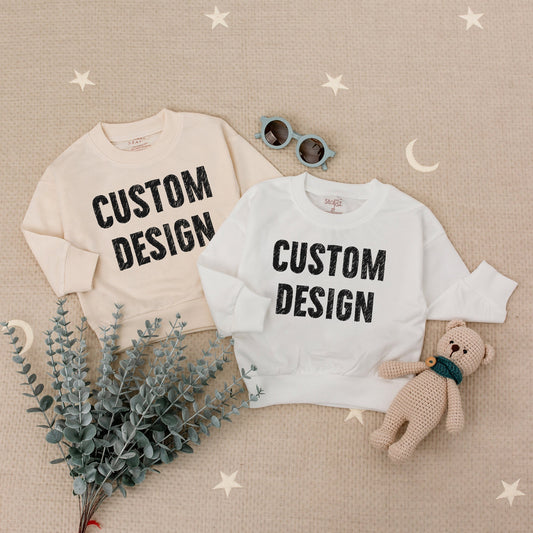 Custom Kids Sweatshirt featuring bold black 'CUSTOM DESIGN' text, a modern comfortable toddler boy girl top perfect for Christmas holiday or baby shower gift
