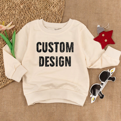 Custom Kids Sweatshirt featuring bold black 'CUSTOM DESIGN' text, a modern comfortable toddler boy girl top perfect for Christmas holiday or baby shower gift
