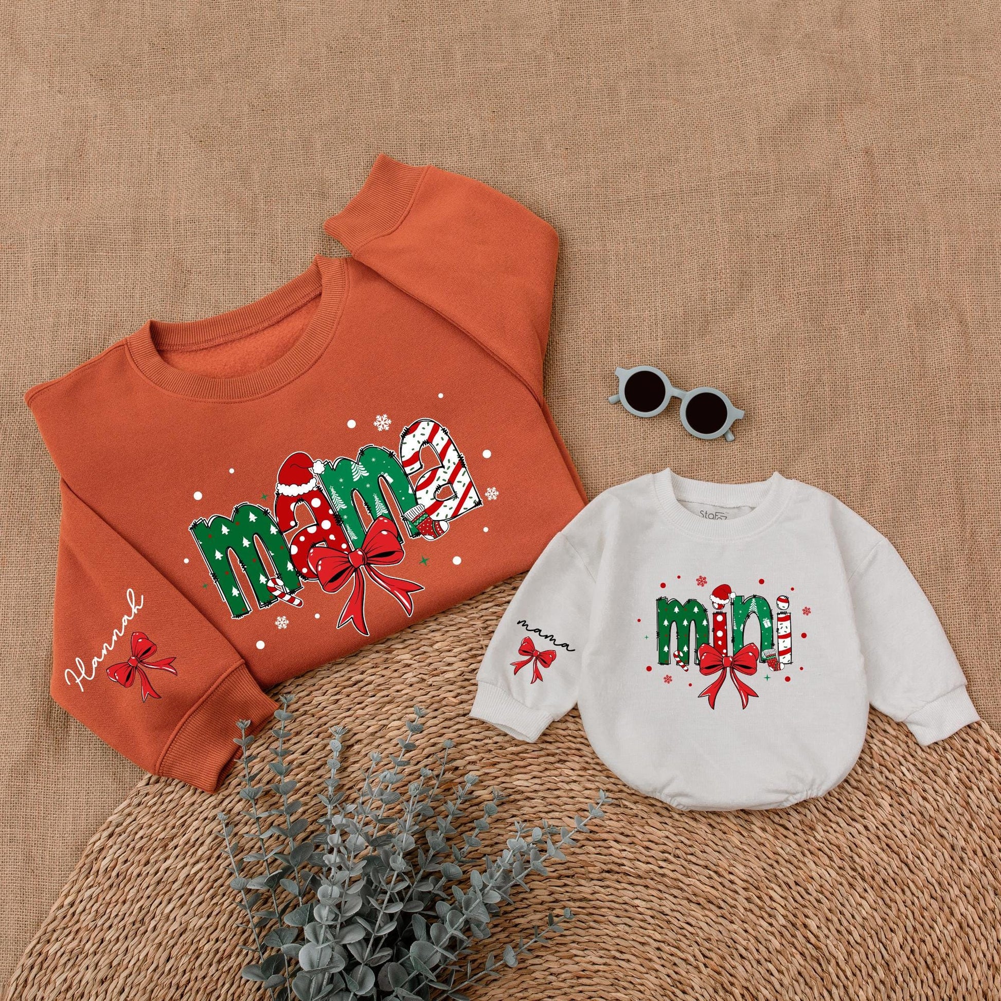 Personalized Christmas Mama Mini Matching Sweatshirt and Baby Romper featuring festive joyful candy cane Santa hat Christmas tree designs and red bows