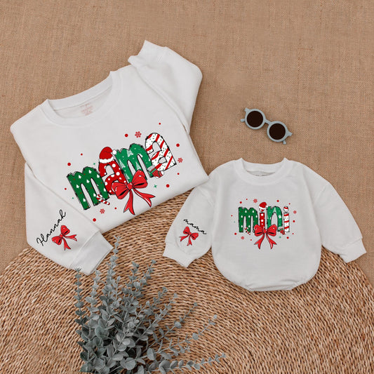 Personalized Christmas Mama Mini Matching Sweatshirt and Baby Romper featuring festive joyful candy cane Santa hat Christmas tree designs and red bows