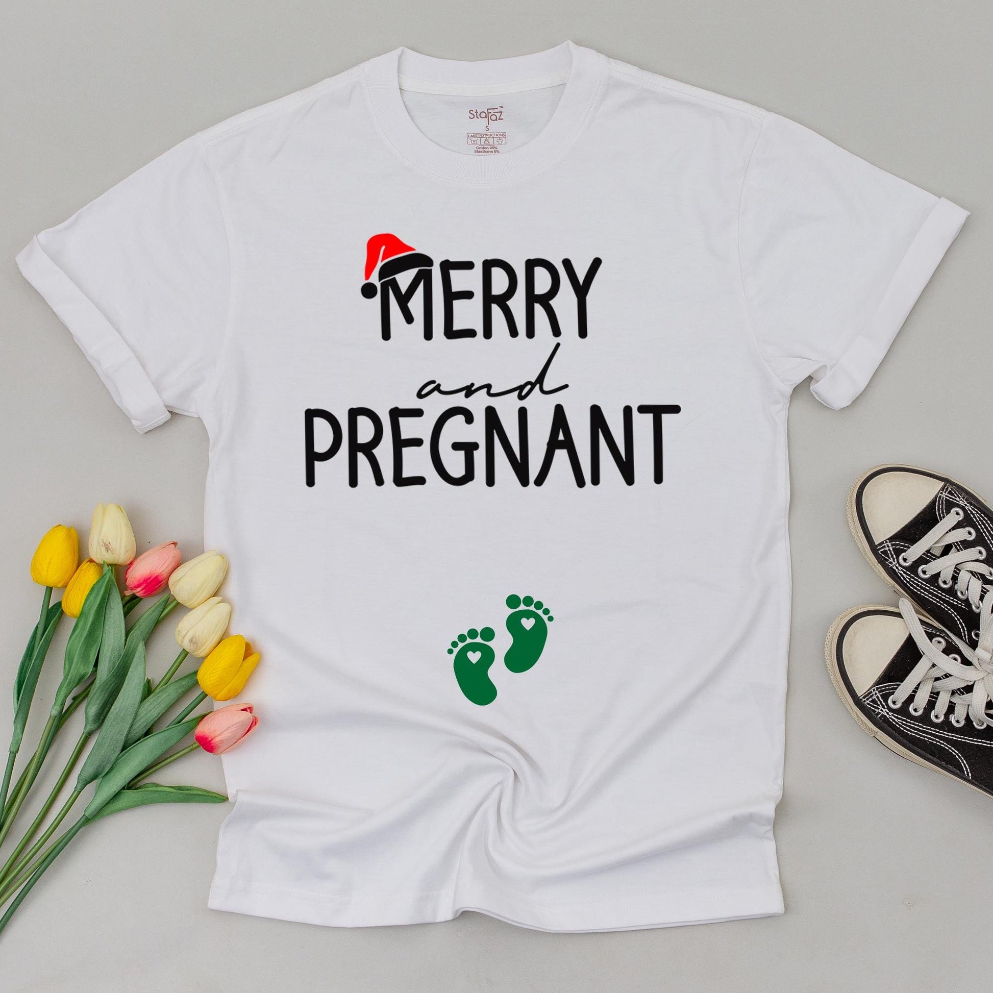 Merry and Pregnant Christmas Maternity Shirt with Santa Hat Design Expecting Mom Gift perfect for a festive pregnancy reveal sweatshirt and comfy holiday sweater.