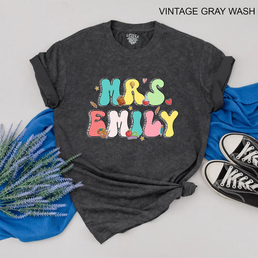 Personalized Teacher Shirt Mrs. Emily Rainbow Name Back to School Outfit, Custom Colorful Letters, Cute Heart Apple Beaker Book Pencil Graphic Gift for Women (138)