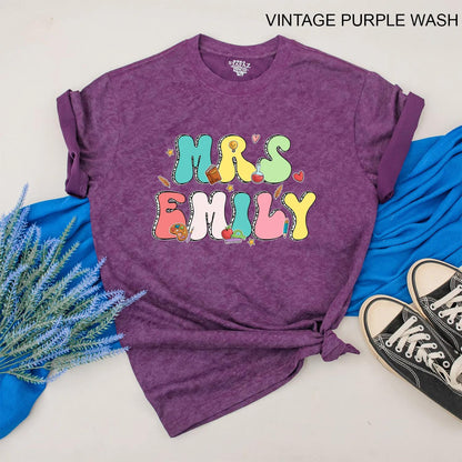 Personalized Teacher Shirt Mrs. Emily Rainbow Name Back to School Outfit, Custom Colorful Letters, Cute Heart Apple Beaker Book Pencil Graphic Gift for Women (138)