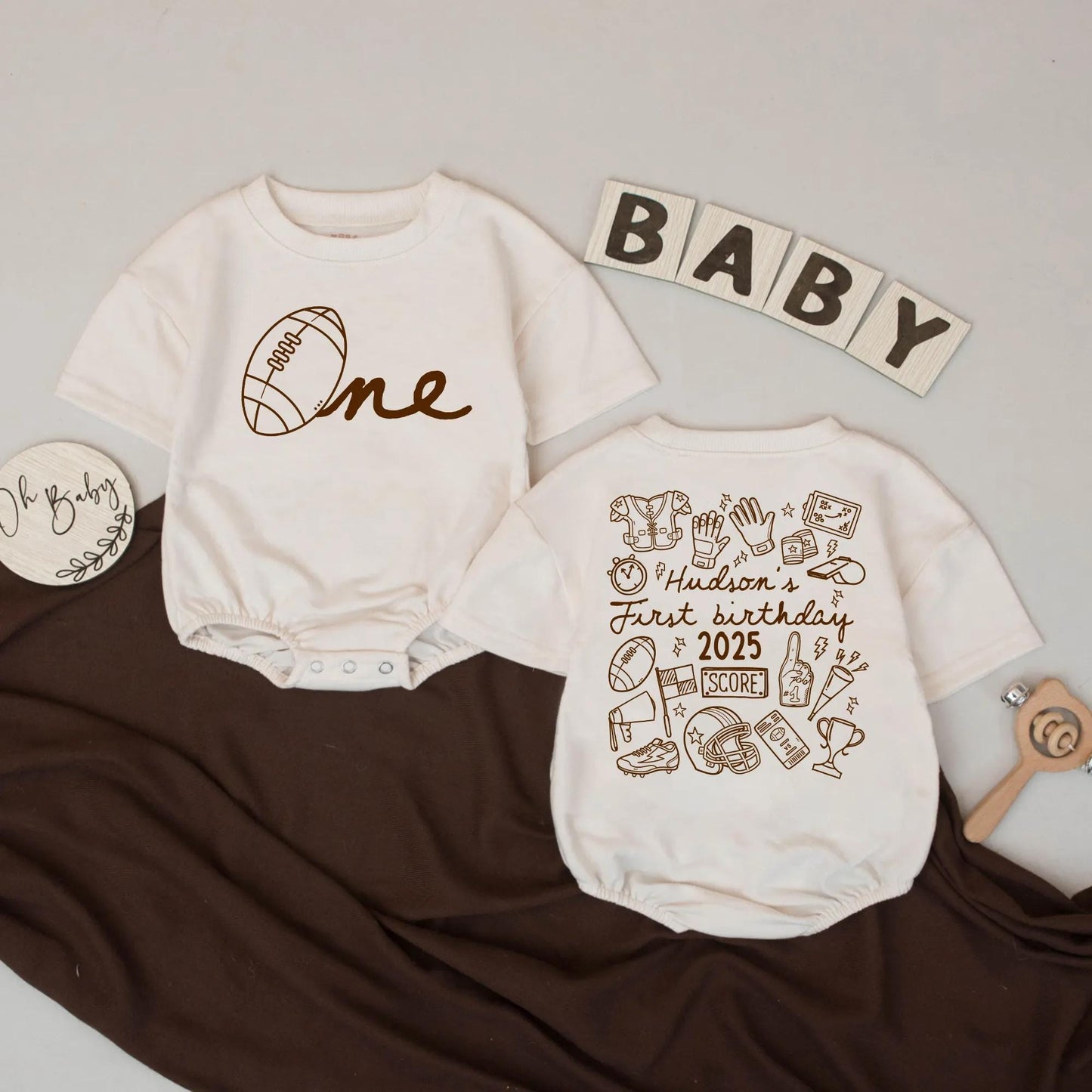 Personalized First Birthday Football Bubble Romper Baby Boy Monochromatic Brown Hand-Drawn Sports One Year Old "One" Design Bodysuit