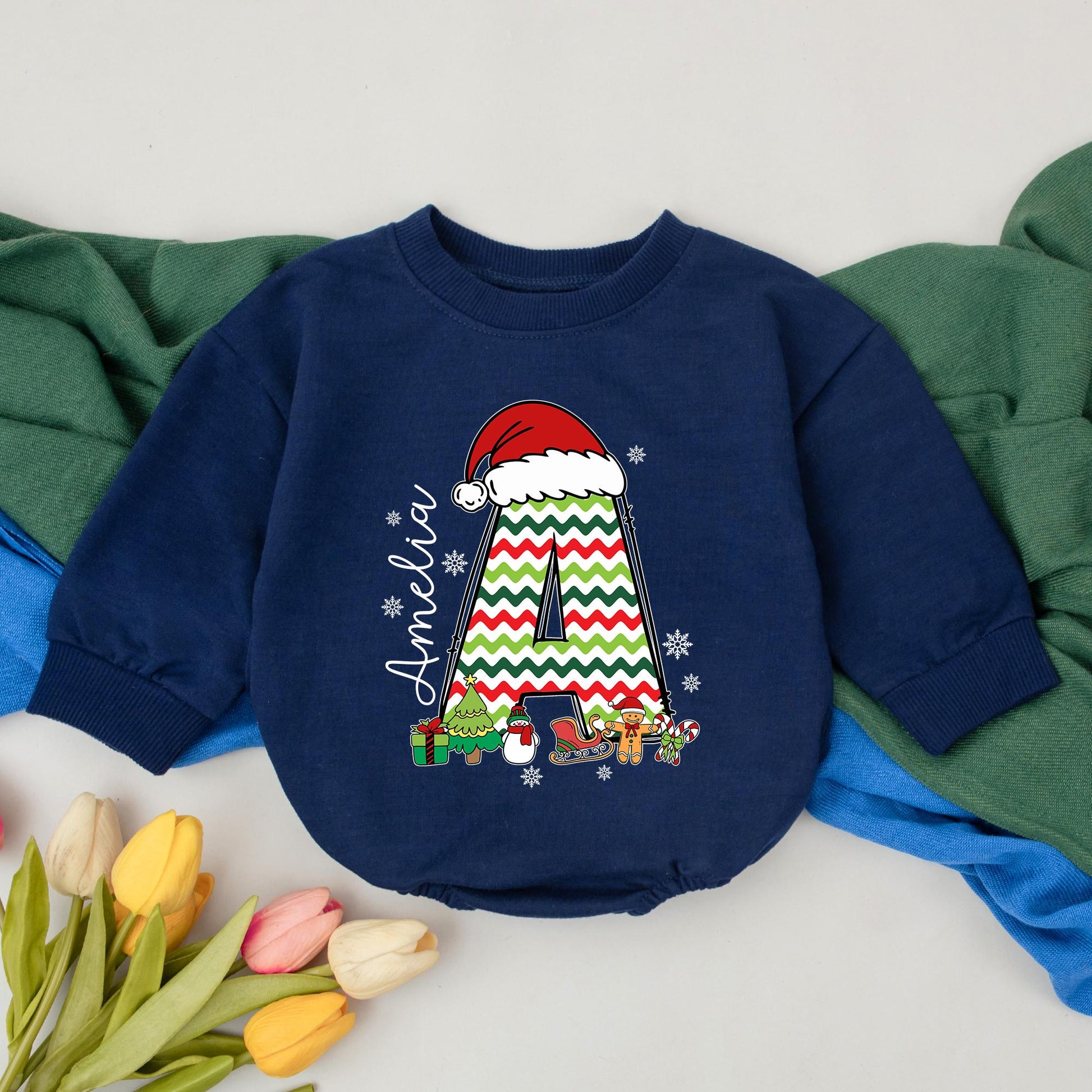 Personalized Name Baby Girl Christmas Bubble Romper featuring a cute Santa hat, zigzag 'A' and fun festive winter characters perfect for a holiday newborn gift