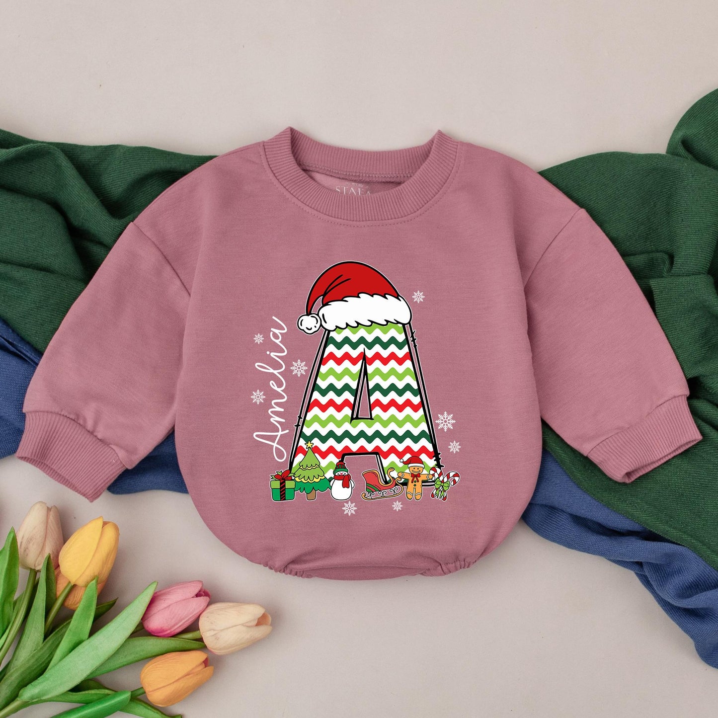 Personalized Name Baby Girl Christmas Bubble Romper featuring a cute Santa hat, zigzag 'A' and fun festive winter characters perfect for a holiday newborn gift
