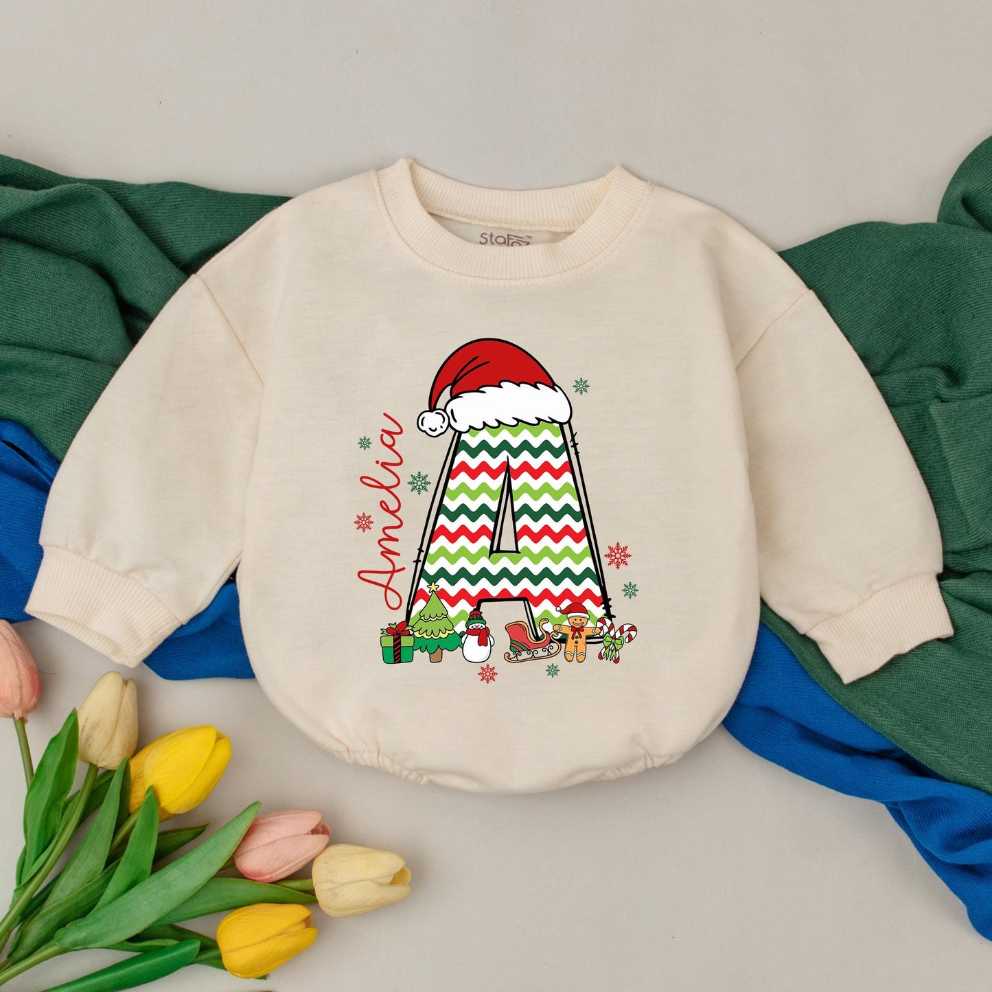 Personalized Name Baby Girl Christmas Bubble Romper featuring a cute Santa hat, zigzag 'A' and fun festive winter characters perfect for a holiday newborn gift