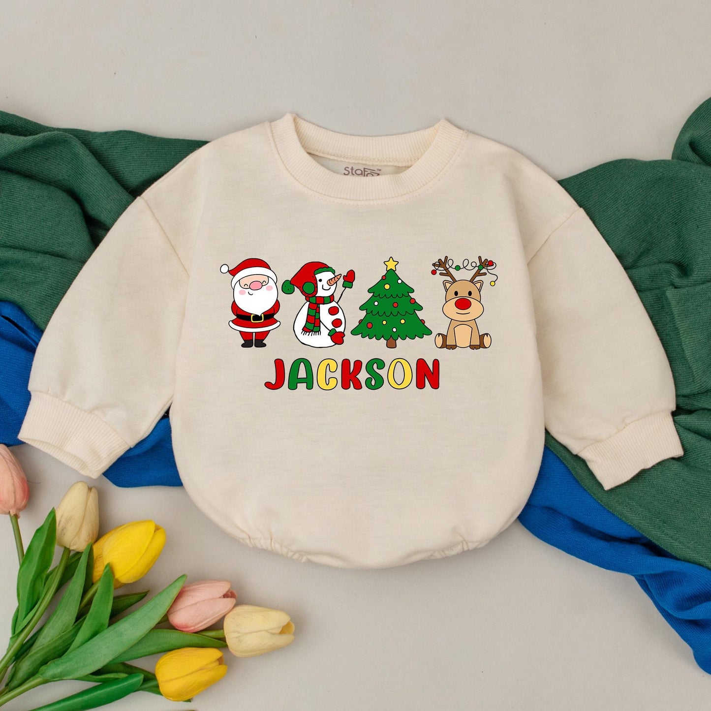 Jackson's First Christmas Bubble Romper Baby Boy Girl with Santa Snowman Tree Reindeer Design Red Green Yellow Colors Joyful Childlike Style