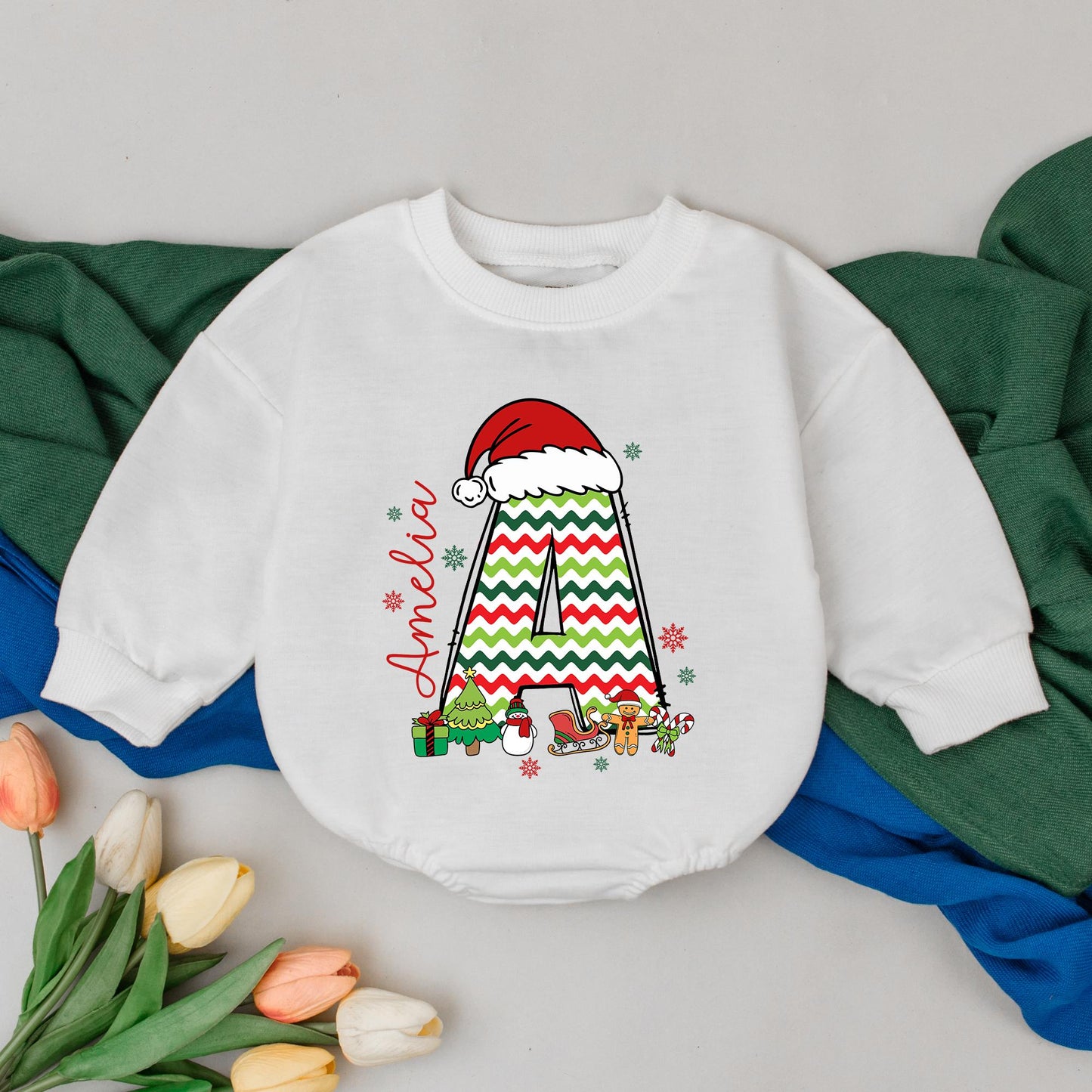 Personalized Name Baby Girl Christmas Bubble Romper featuring a cute Santa hat, zigzag 'A' and fun festive winter characters perfect for a holiday newborn gift