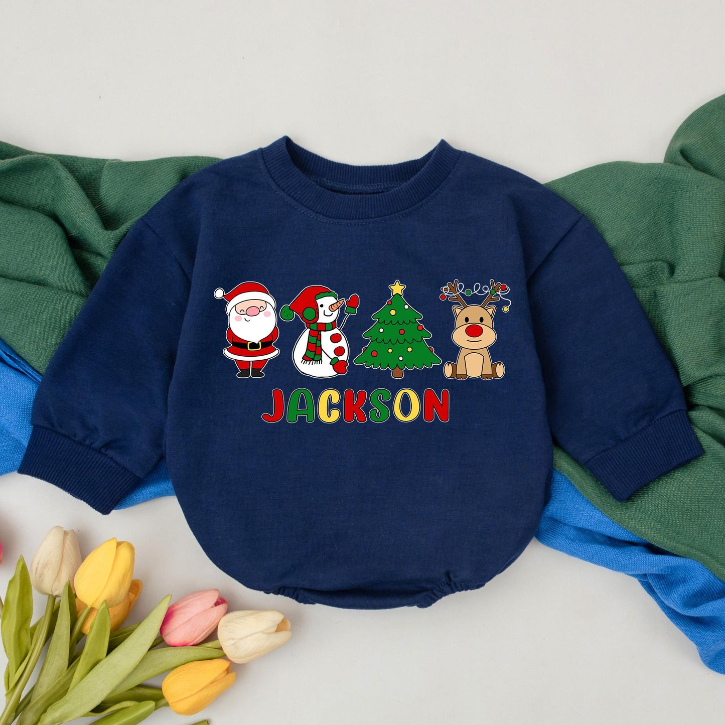 Jackson's First Christmas Bubble Romper Baby Boy Girl with Santa Snowman Tree Reindeer Design Red Green Yellow Colors Joyful Childlike Style