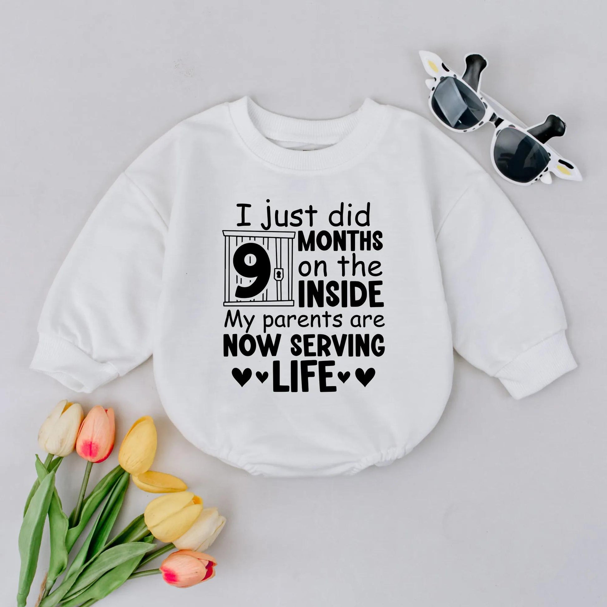 Funny Newborn Baby '9 Months On The Inside' Romper with Jail Bar Design Padlock Detail & 'Parents Serving Life' Text. Perfect Coming Home Outfit or Baby Announcement Gift Bodysuit.